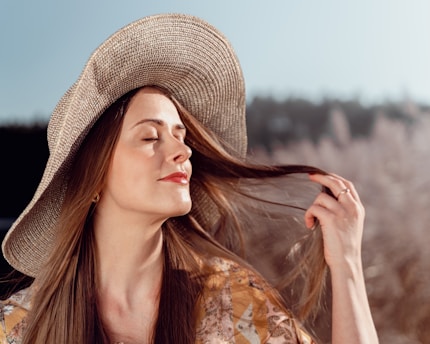 a woman with long hair wearing a hat