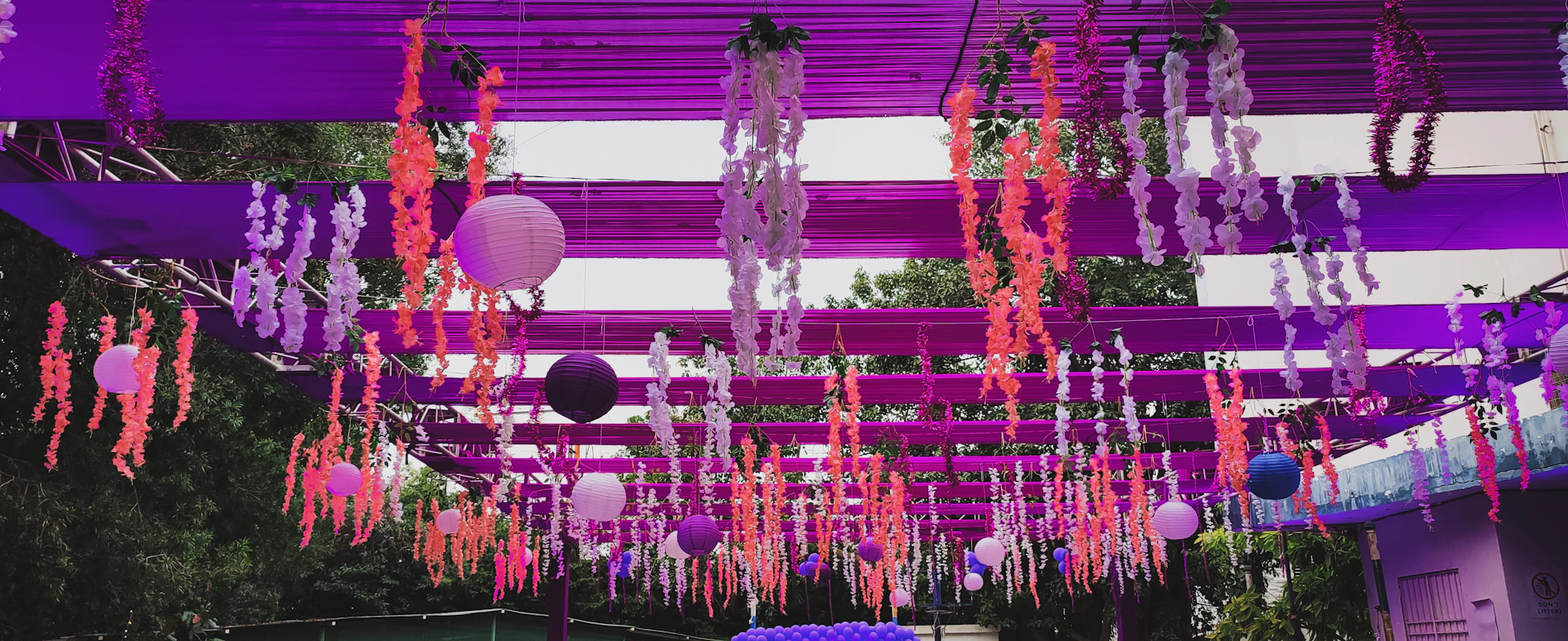 purple and pink decorations hanging from the ceiling