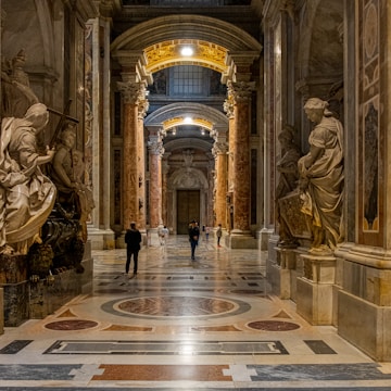 a couple of people that are standing in a hallway