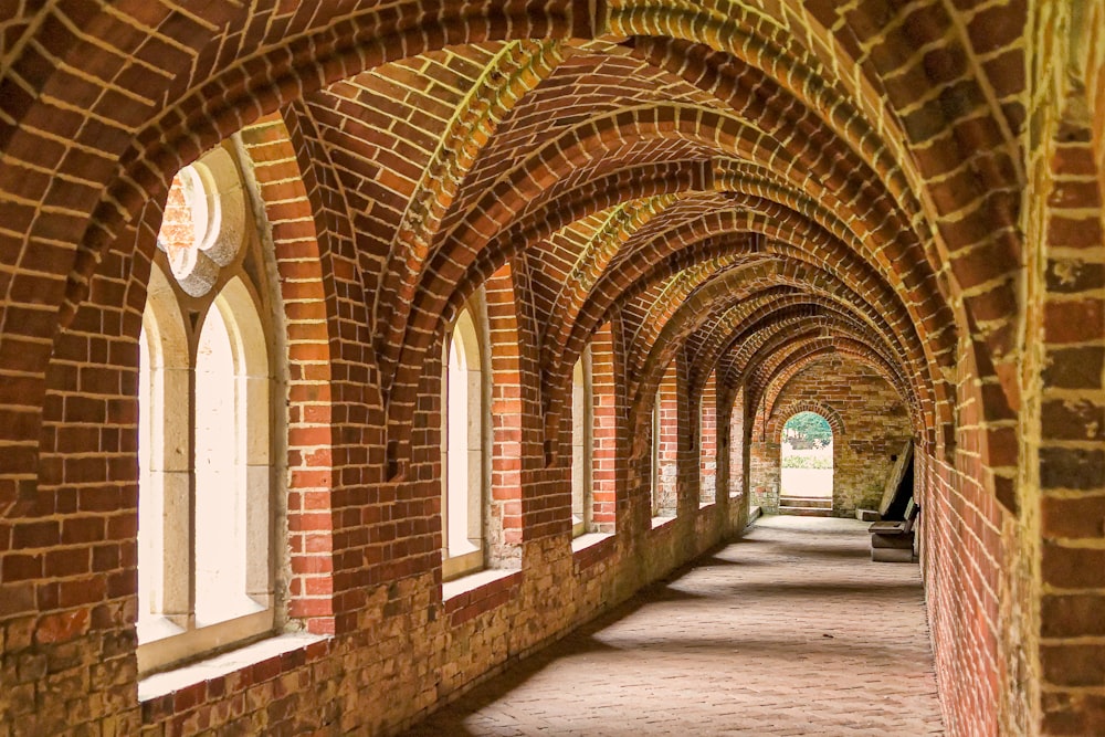 a long brick tunnel with arched windows