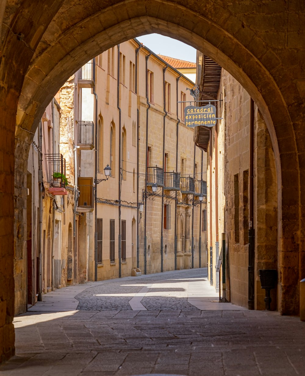 an arch in a stone building with a clock on it