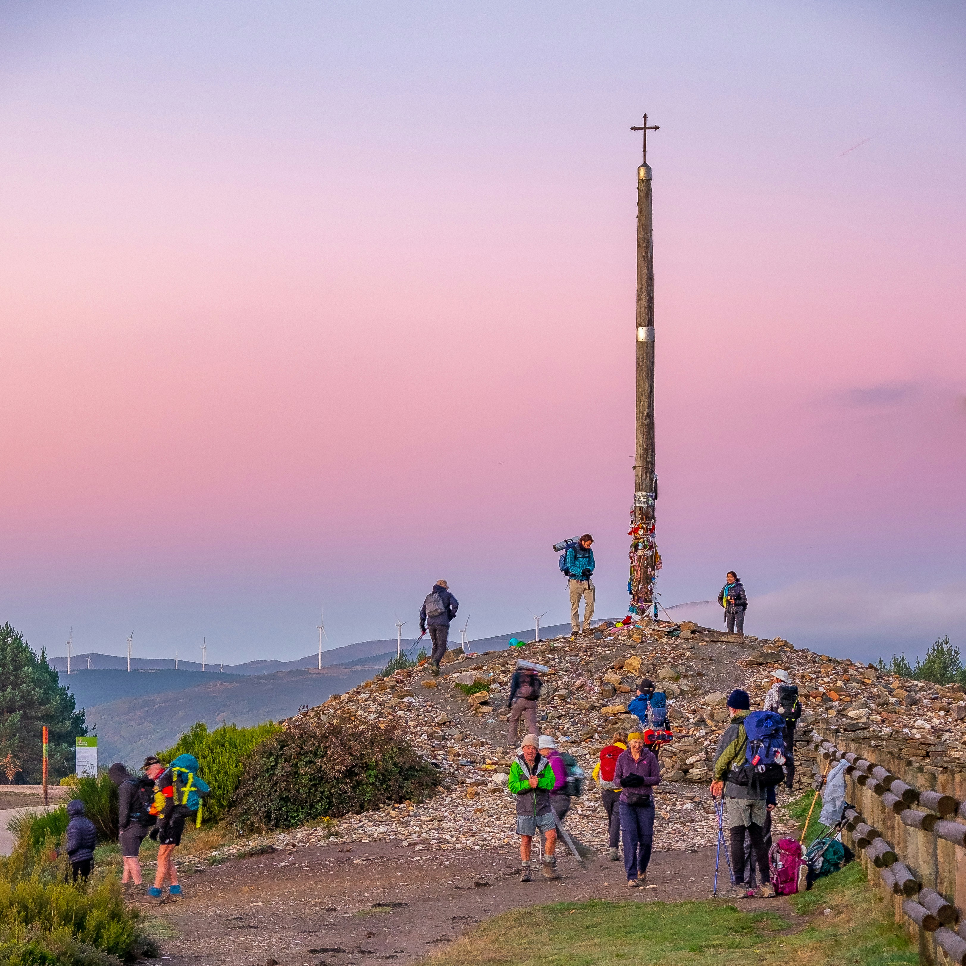 a group of people standing on top of a hill