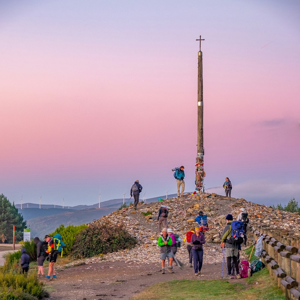 a group of people standing on top of a hill