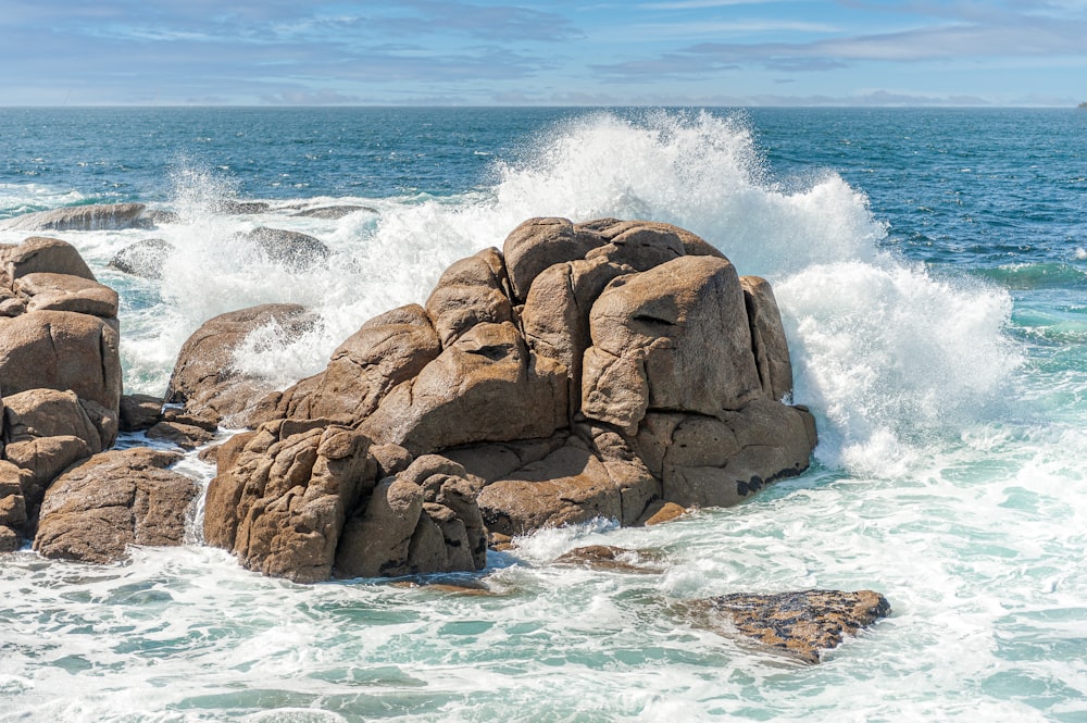 a large body of water next to a rocky shore