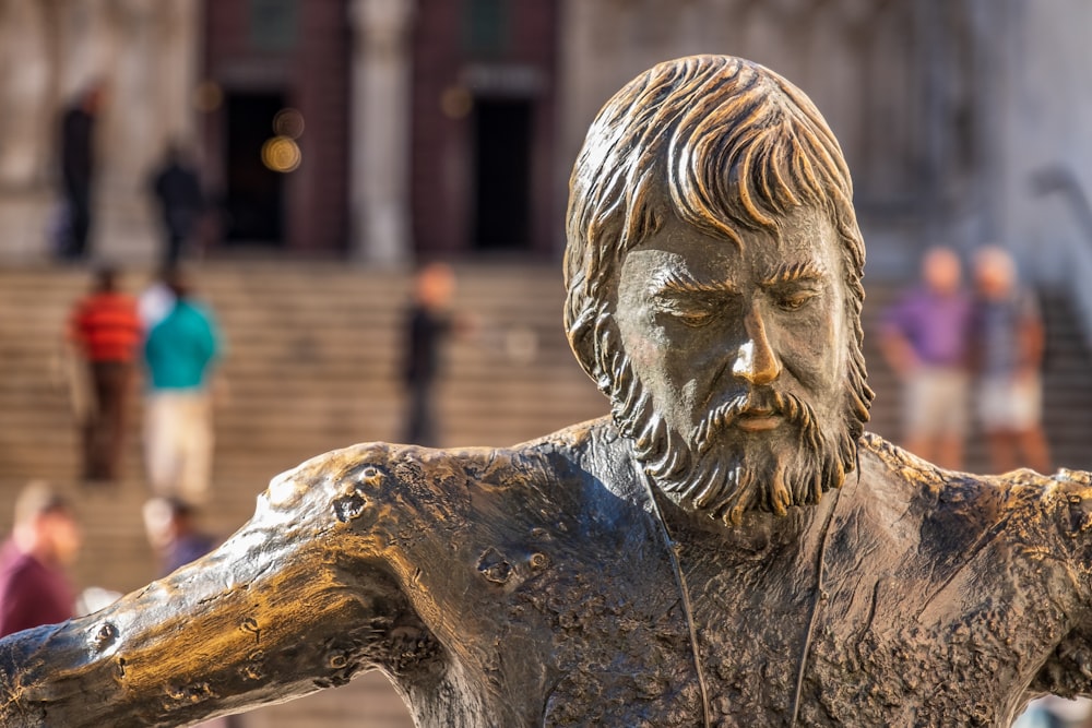 a bronze statue of a man with a beard