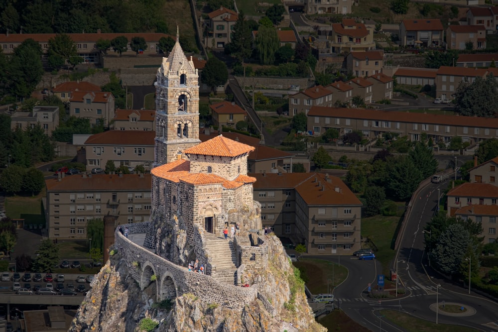 a tall tower with a red roof on top of a mountain