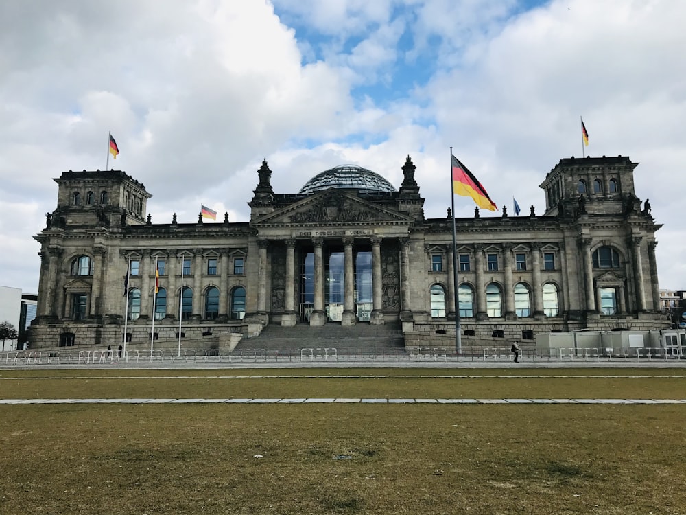 a large building with flags flying in front of it