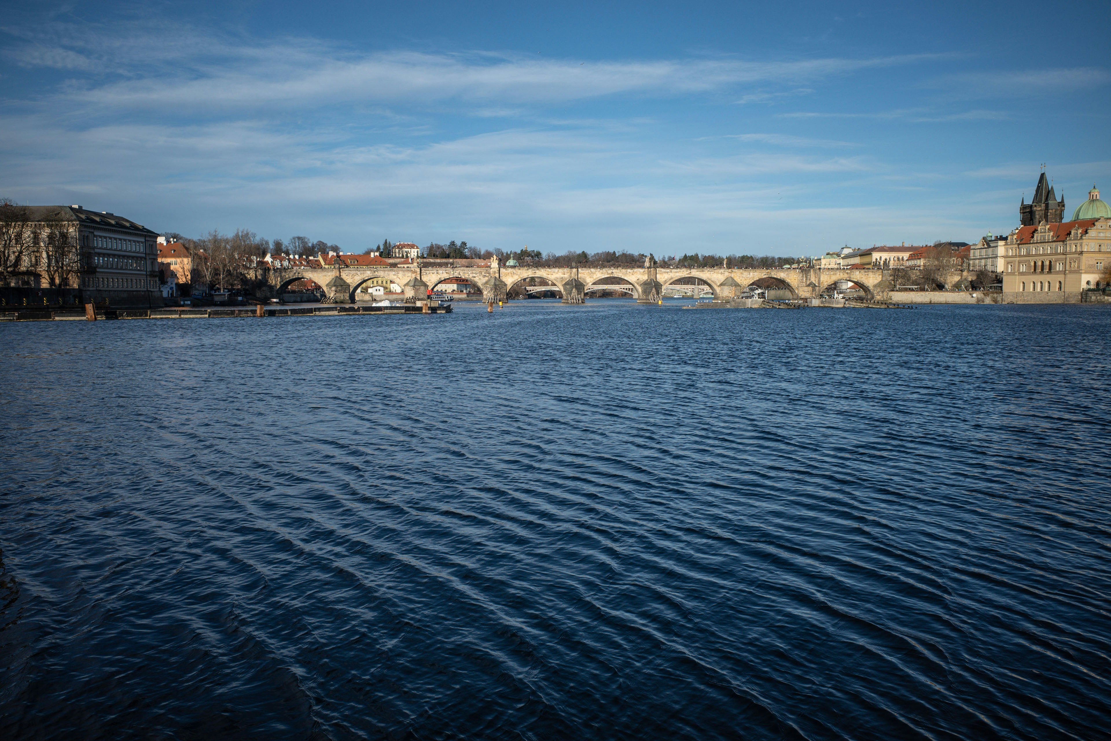 a large body of water with a bridge in the background