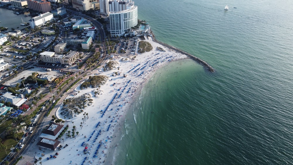 an aerial view of a beach with a city in the background