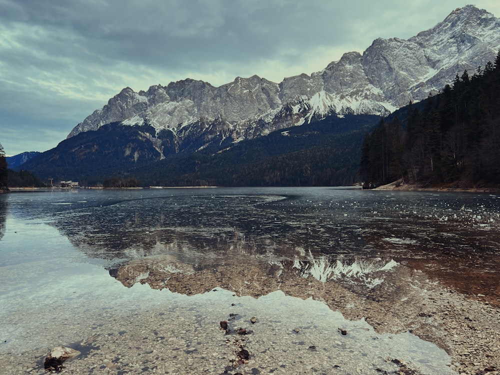 a body of water with mountains in the background