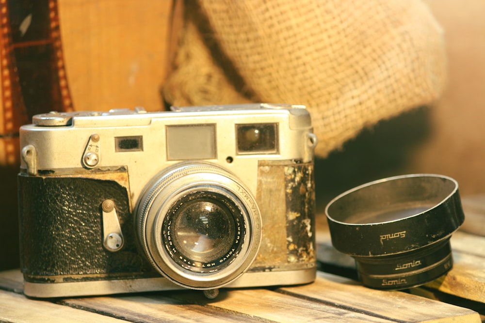 an old camera sitting on top of a wooden table