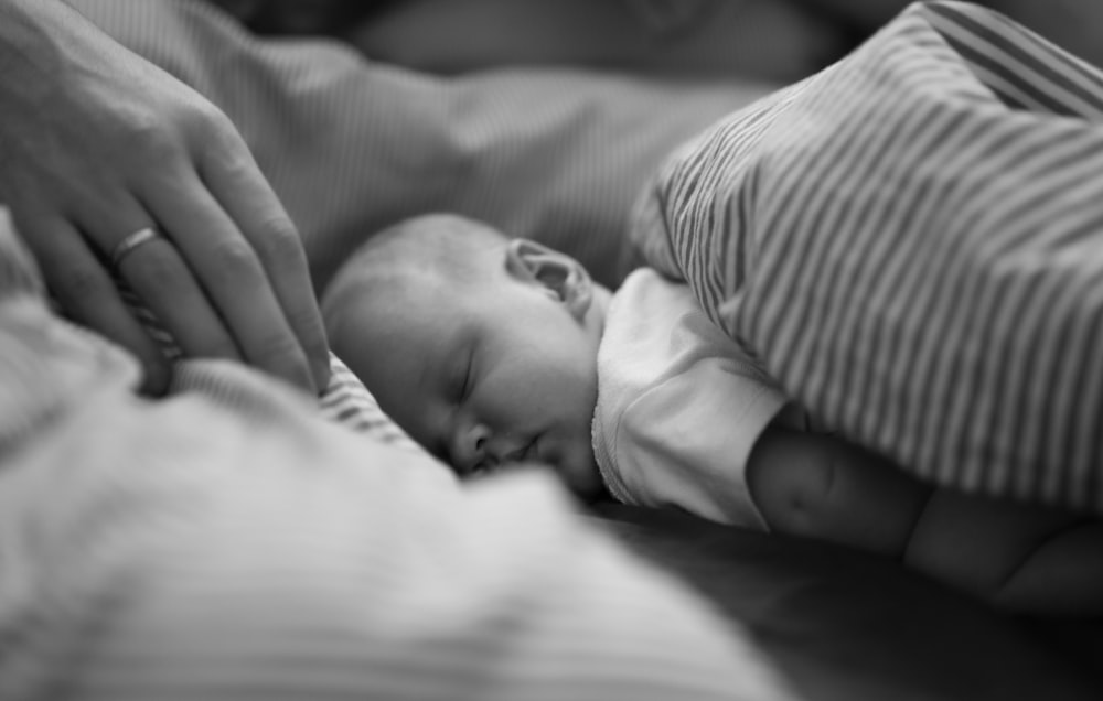 a woman holding a baby in her arms