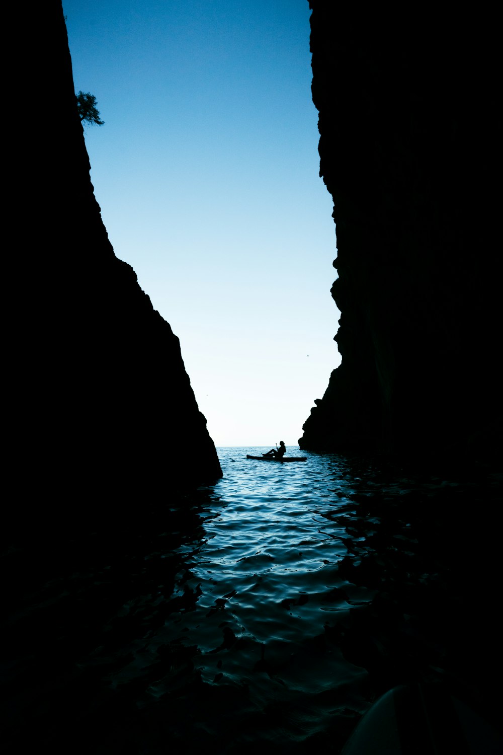 a person in a small boat in a body of water