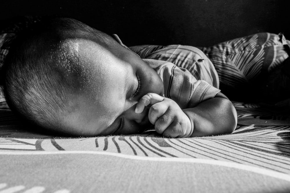 a black and white photo of a baby sleeping