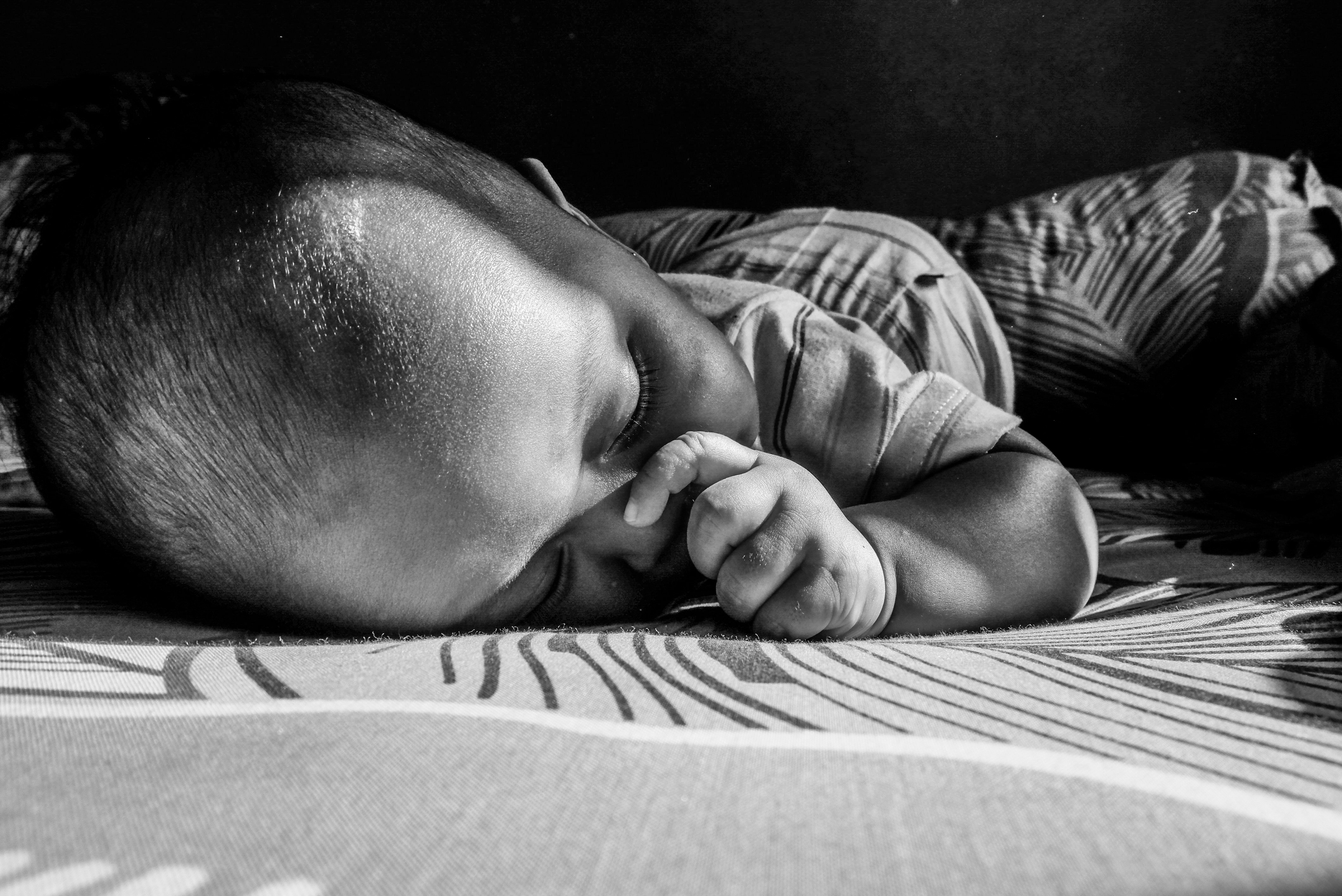 a black and white photo of a baby sleeping