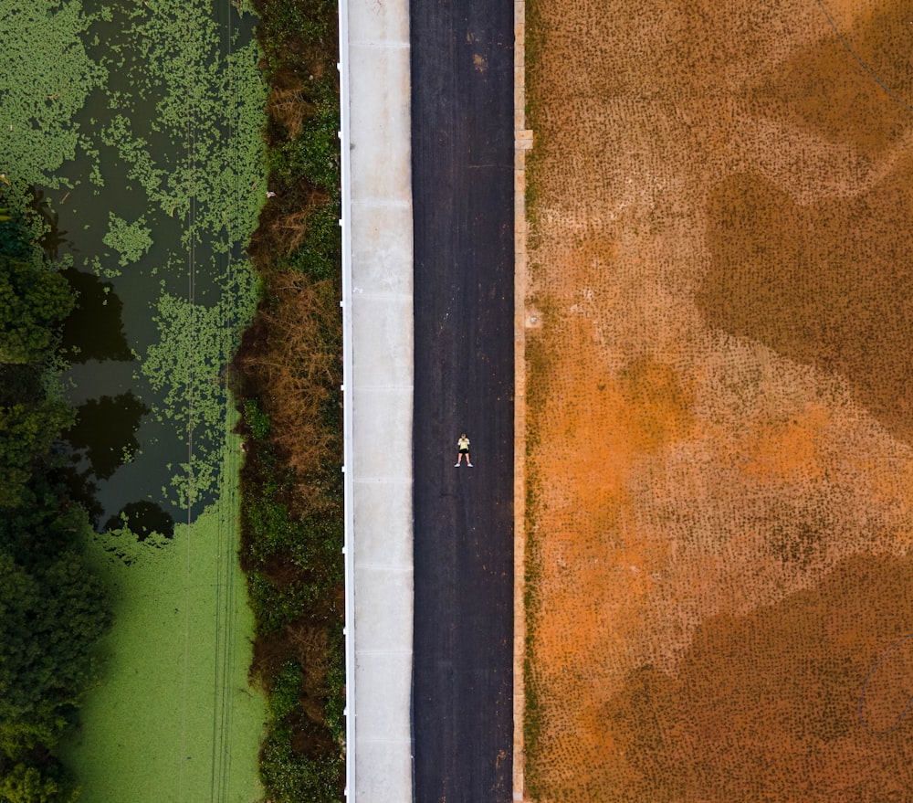 an aerial view of a road and a field