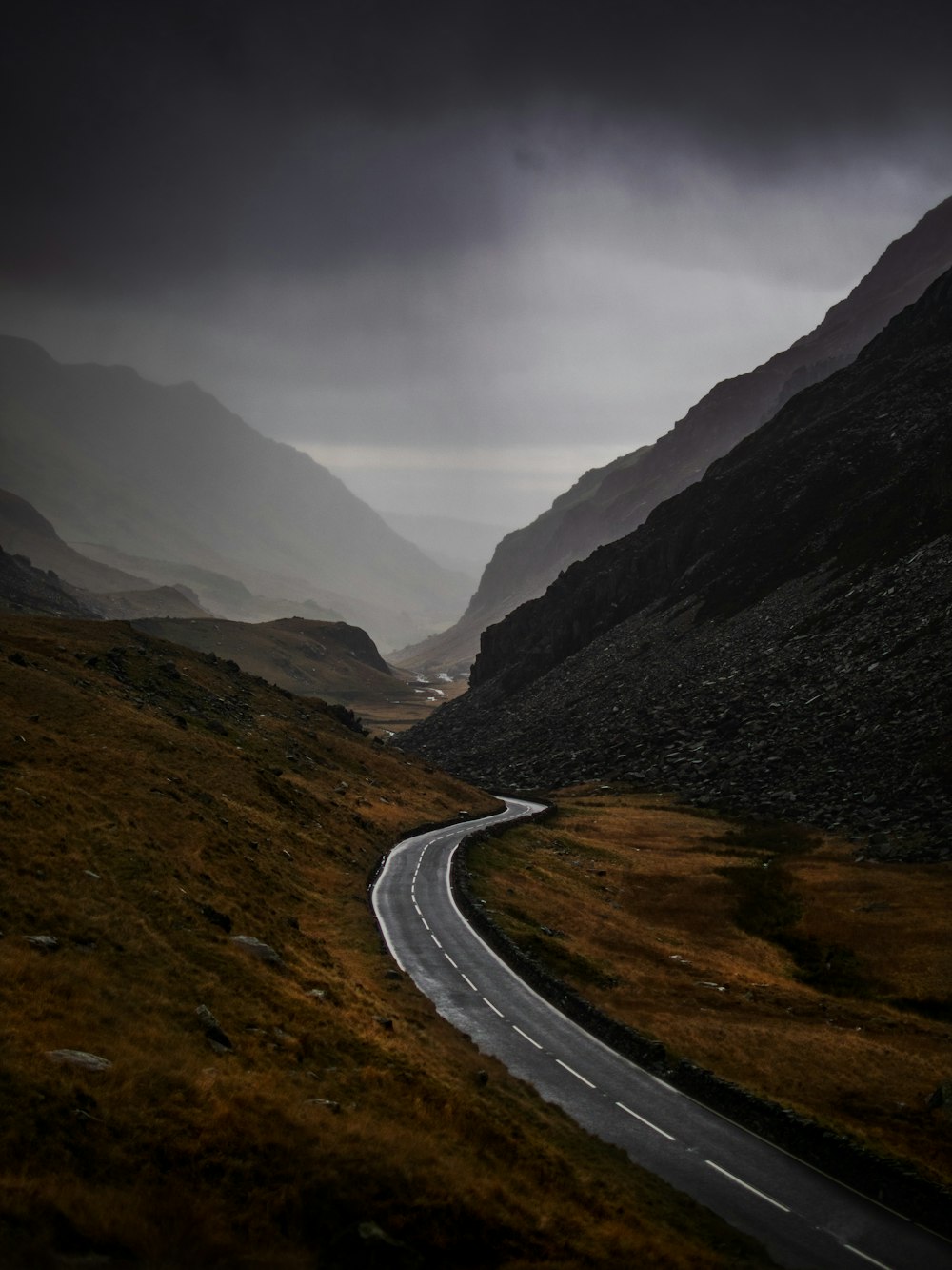 a winding road in the middle of a mountain range