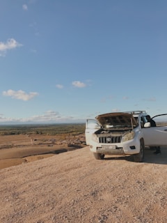 a white truck with a surfboard on top of it