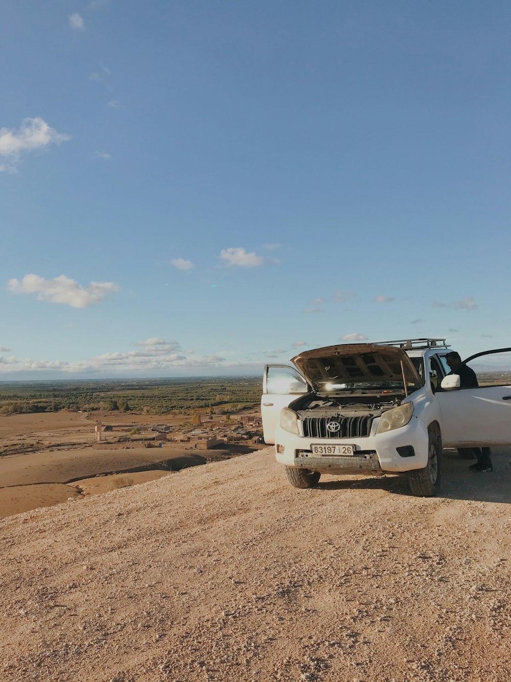 a white truck with a surfboard on top of it