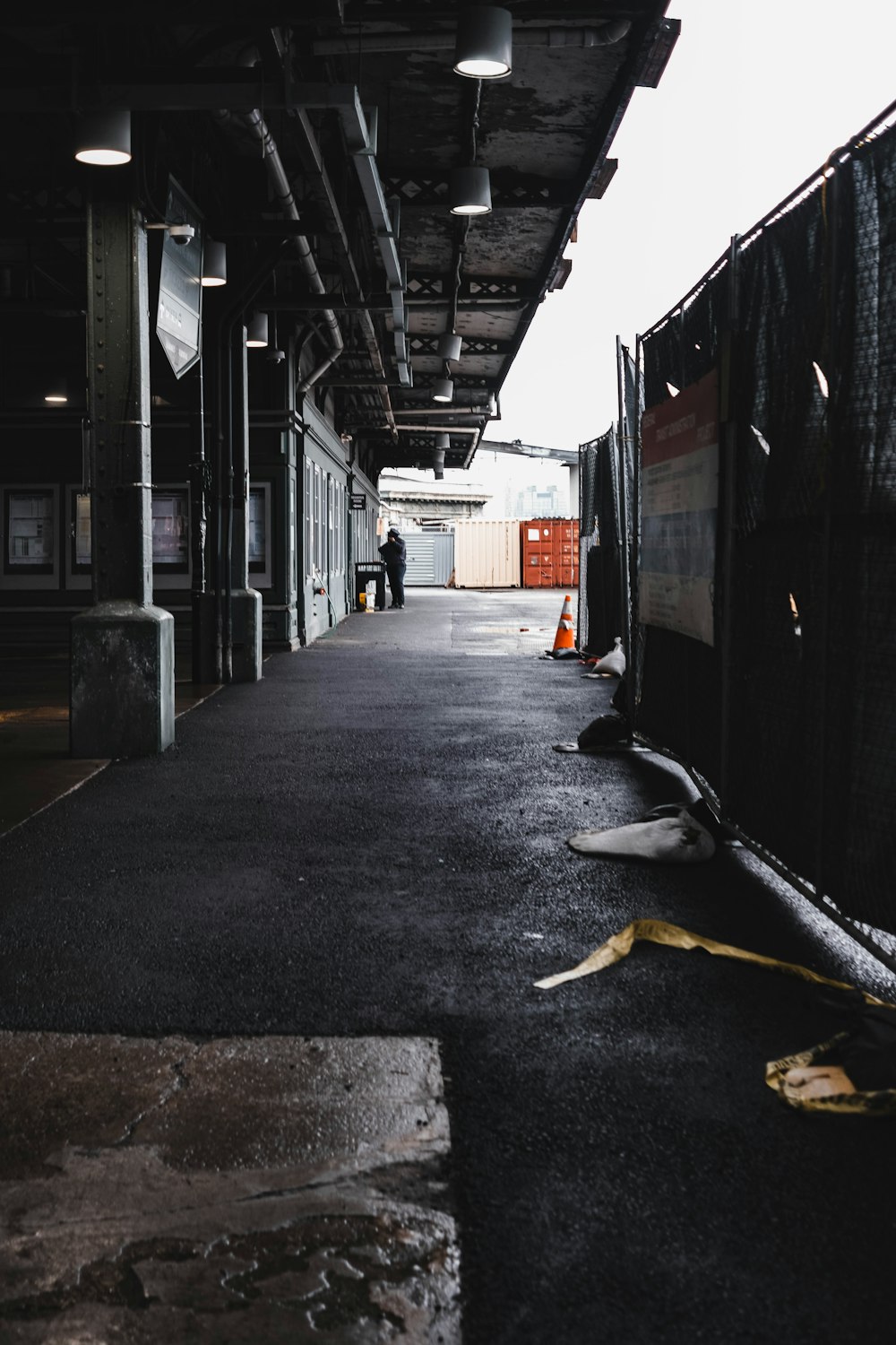 a man is standing in an empty train station