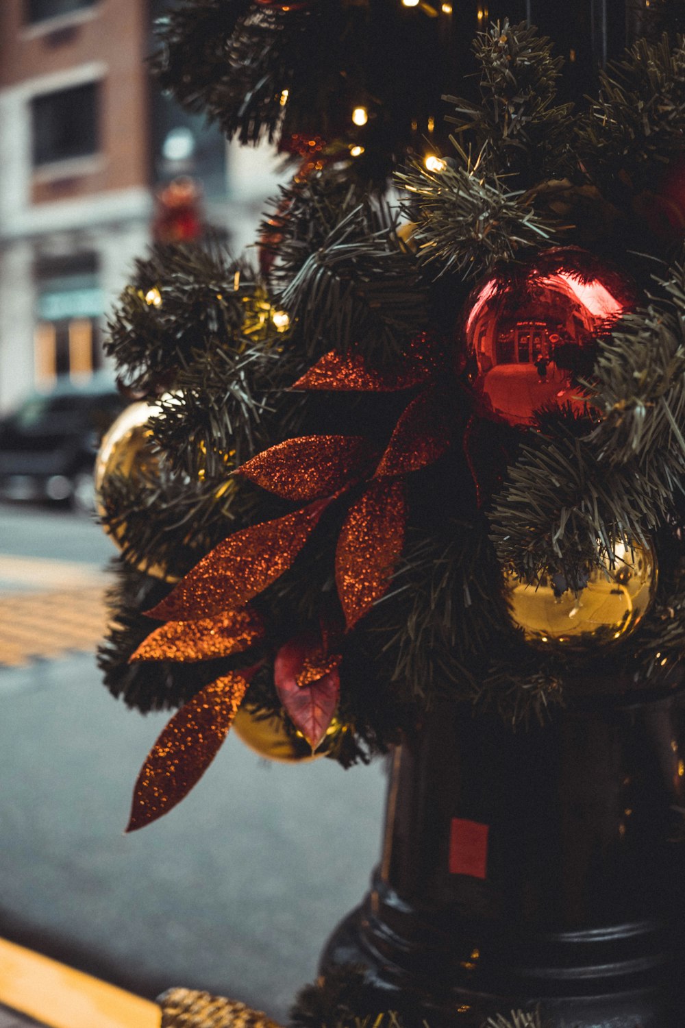 a decorated christmas tree on a city street