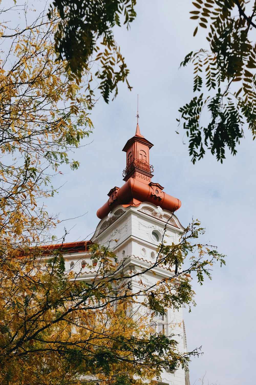 a tall white building with a clock on the top