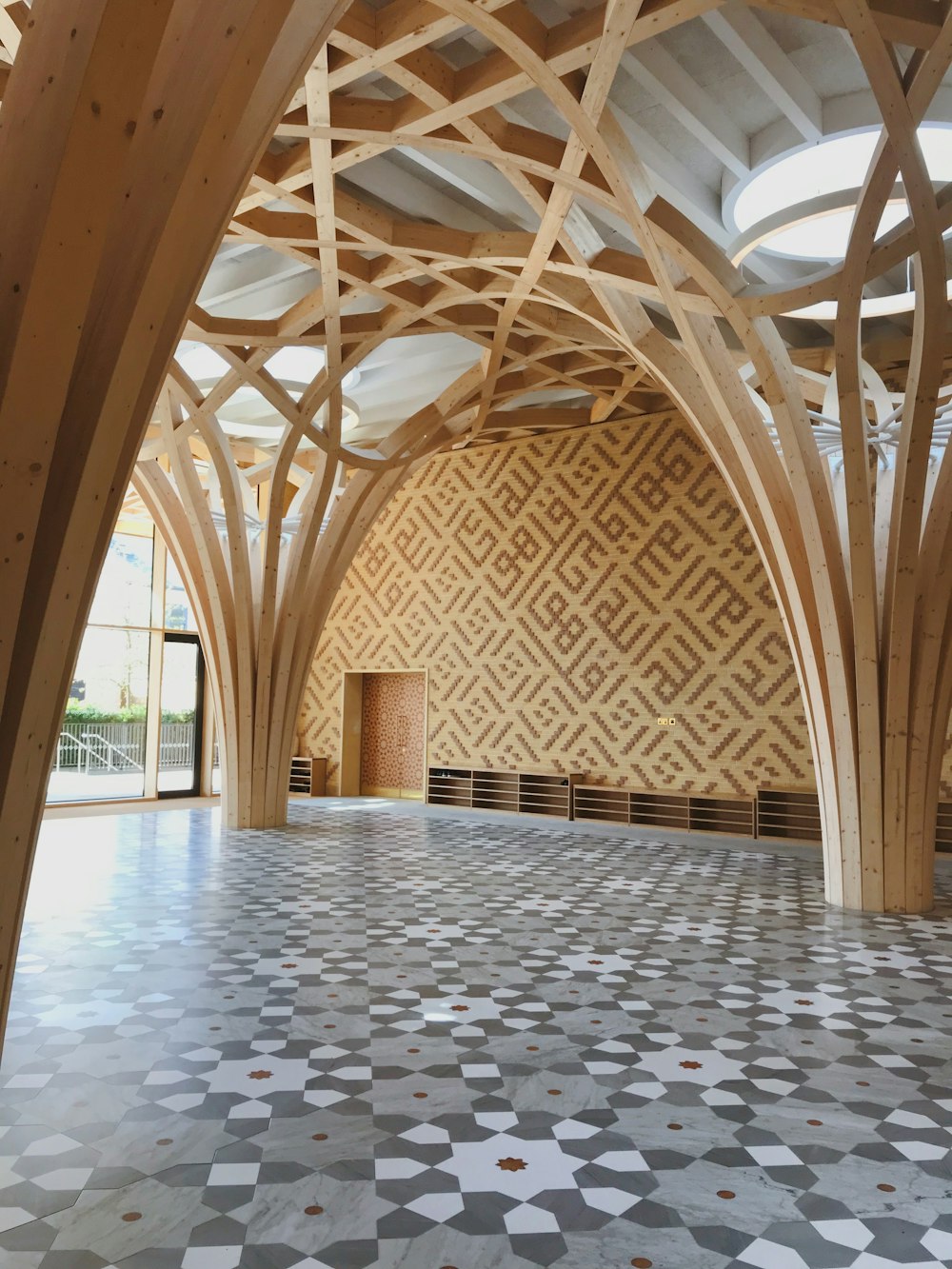 a large room with wooden beams and a tiled floor