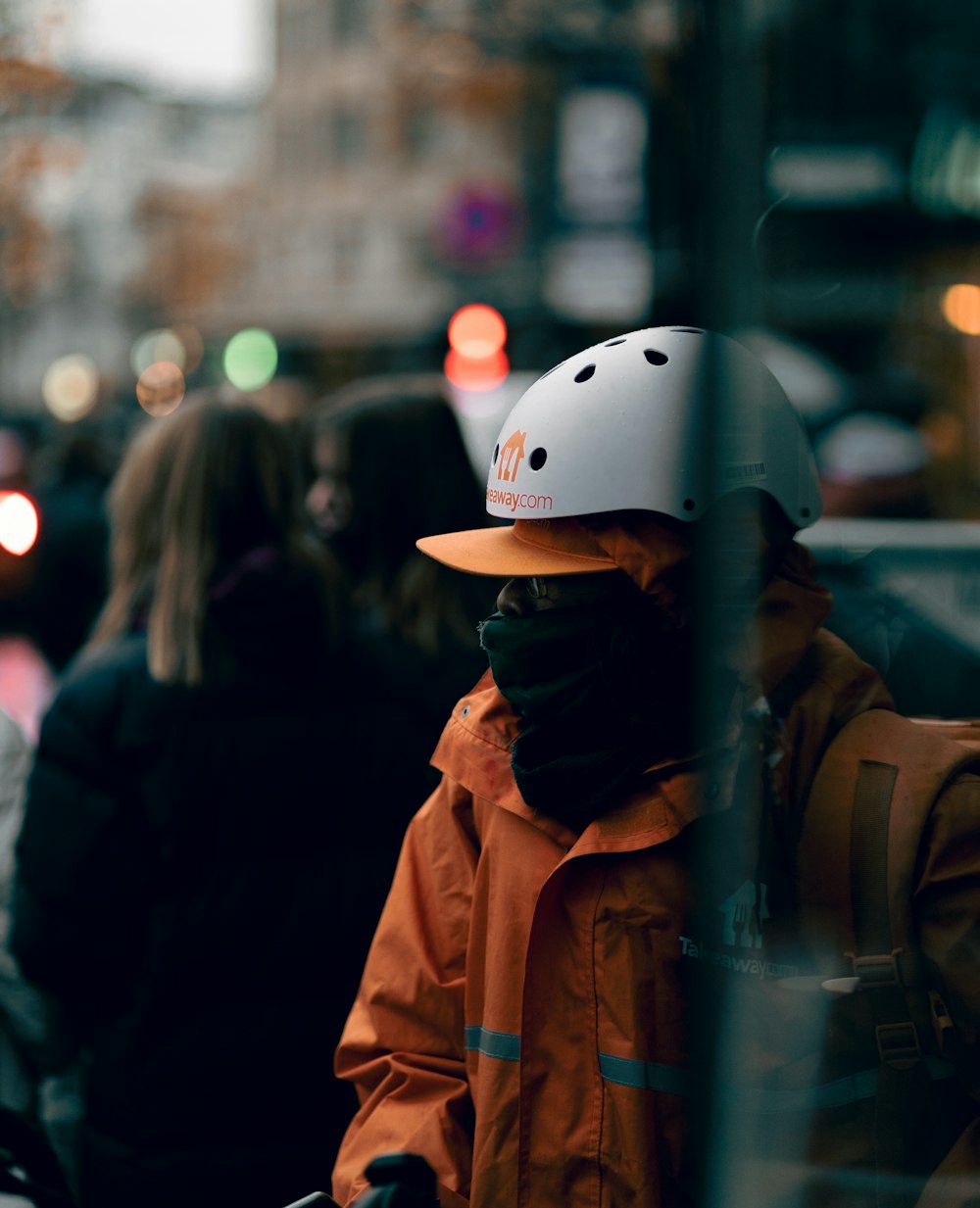 a person in an orange jacket and a white helmet