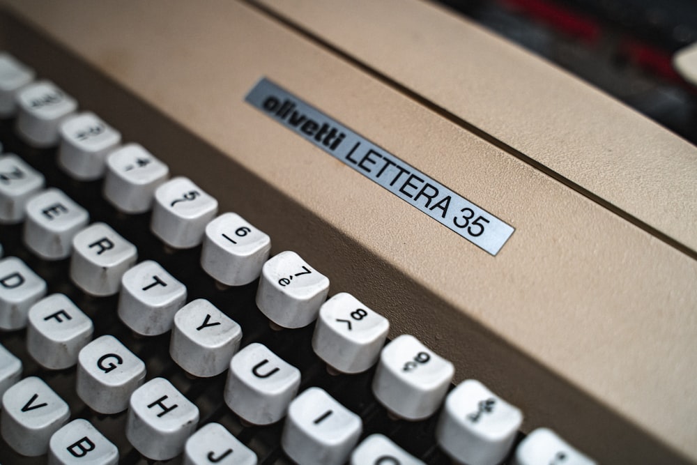 a close up of an old typewriter with a sticker on it