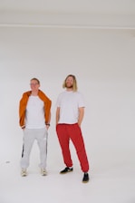 A smiling woman and man wearing chic, comfortable kixoraa shirts in a bright, casual setting.