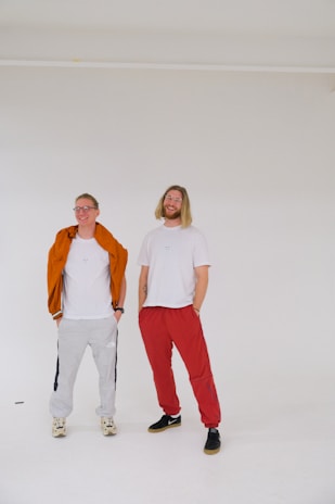 A smiling woman and man wearing chic, comfortable kixoraa shirts in a bright, casual setting.