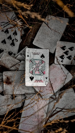 a pile of playing cards laying on top of each other