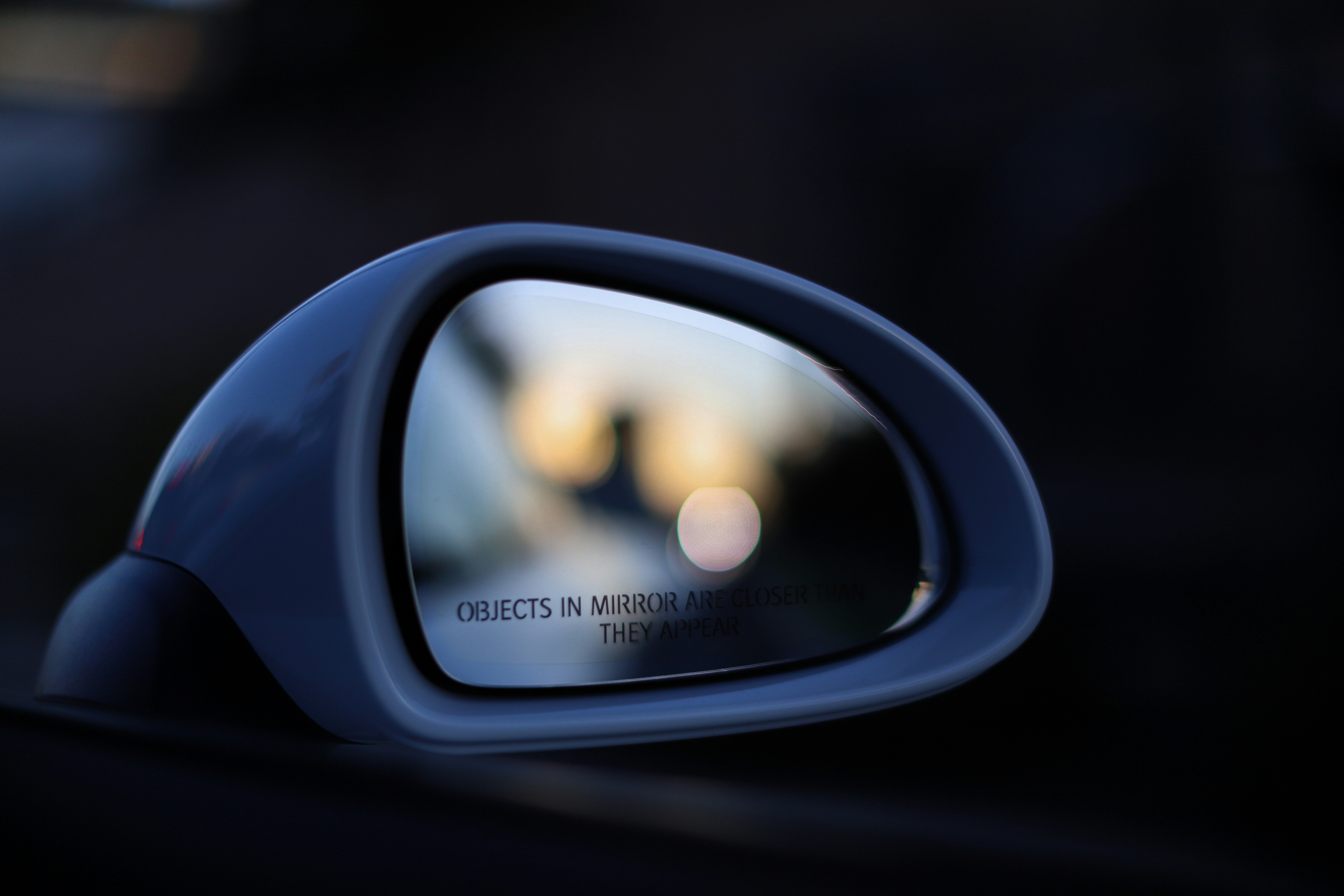 a side view mirror on a car with a blurry background
