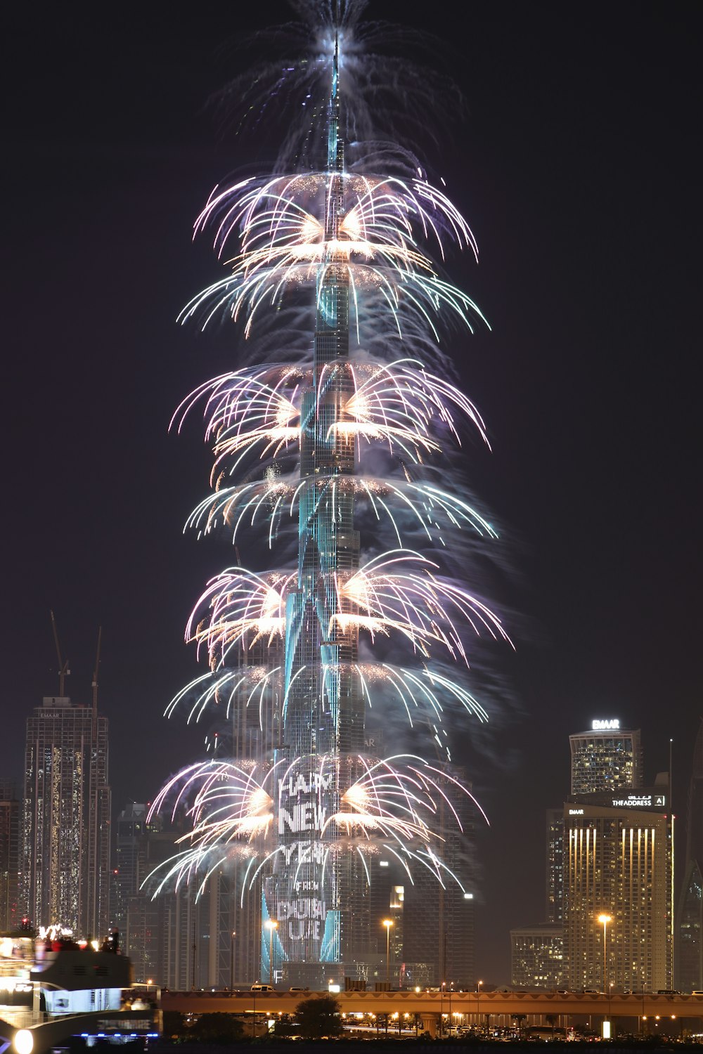 a very tall building with a lot of fireworks in the sky