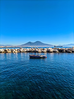 a small boat floating on top of a body of water