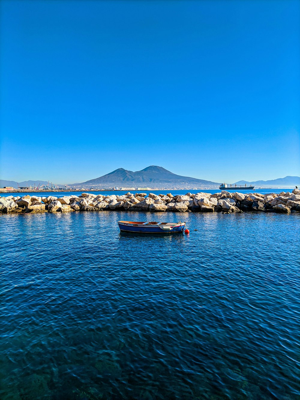 a small boat floating on top of a body of water