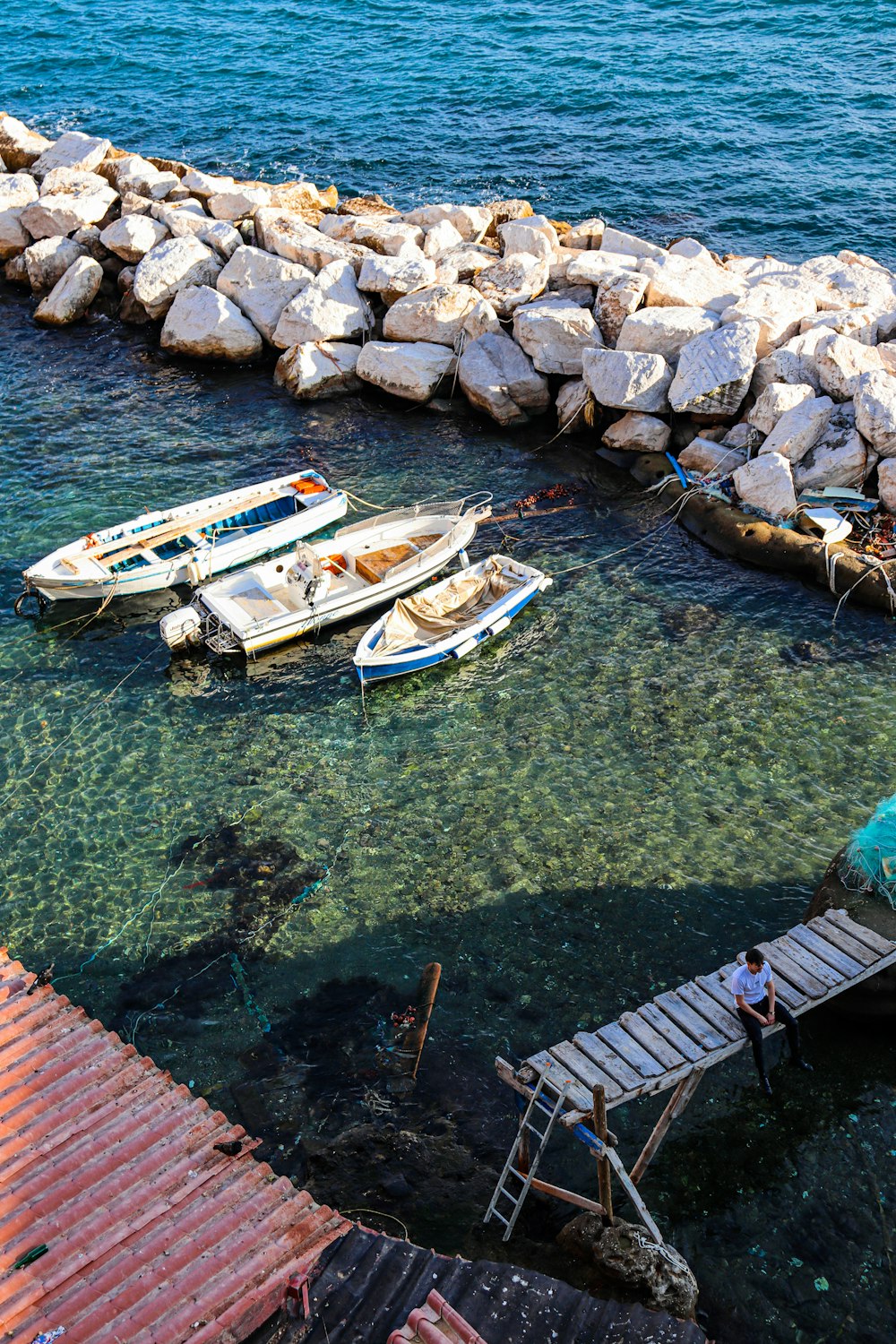 a group of boats sitting on top of a body of water