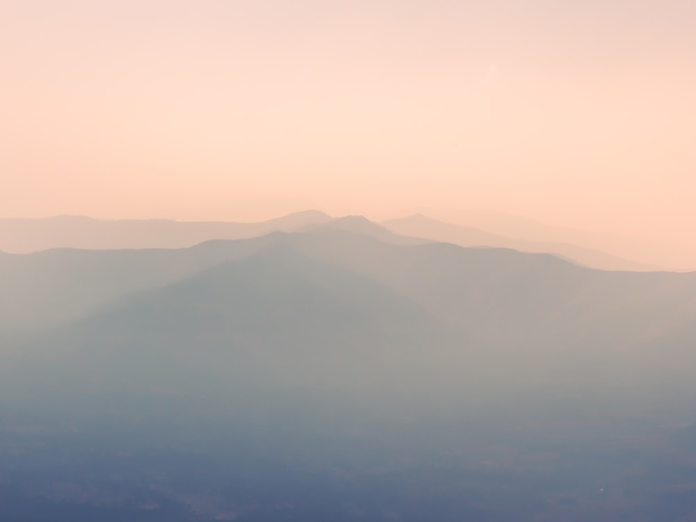 a hazy sky with mountains in the distance