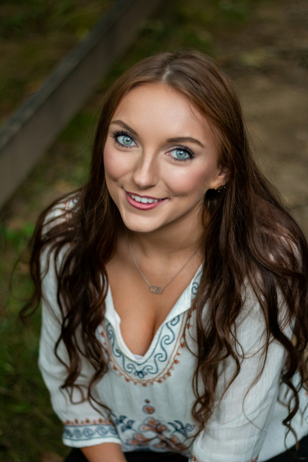 a woman with long hair and blue eyes posing for a picture