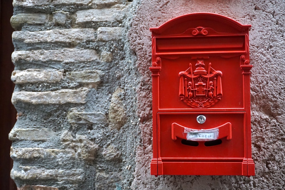 a red mailbox on the side of a building