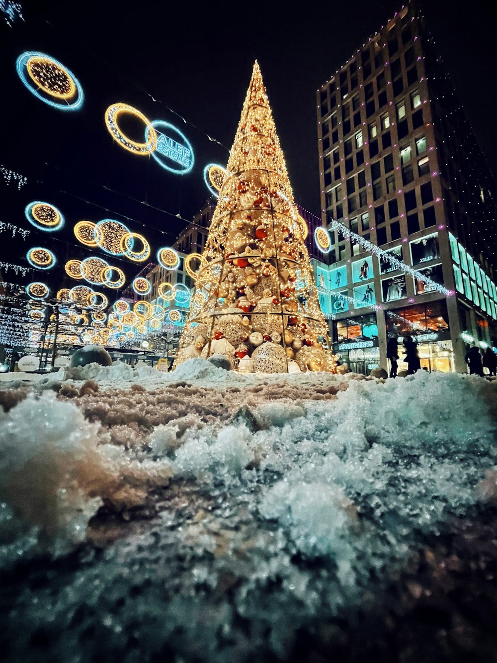 a large christmas tree in the middle of a street