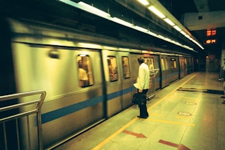 a man is waiting for a train at a subway station