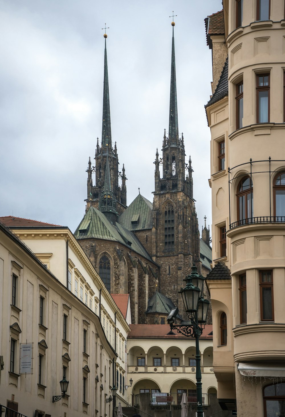 a large cathedral towering over a city filled with tall buildings