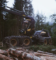 a tractor is parked in the middle of a forest