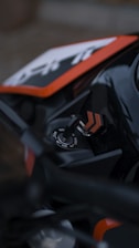 a close up of a motorcycle with a black and orange frame