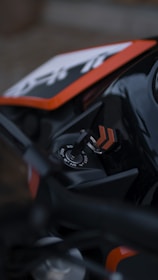 a close up of a motorcycle with a black and orange frame