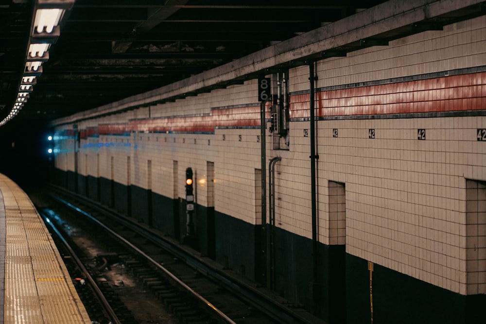 a train pulling into a train station next to a platform