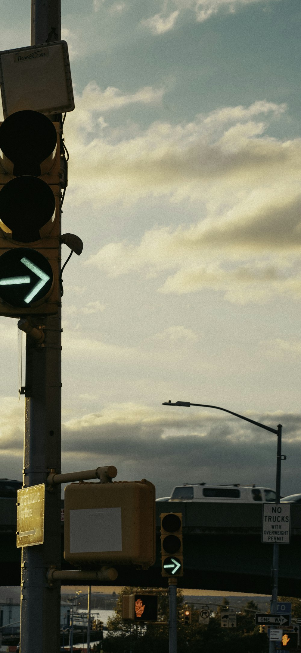 a traffic light with a train in the background