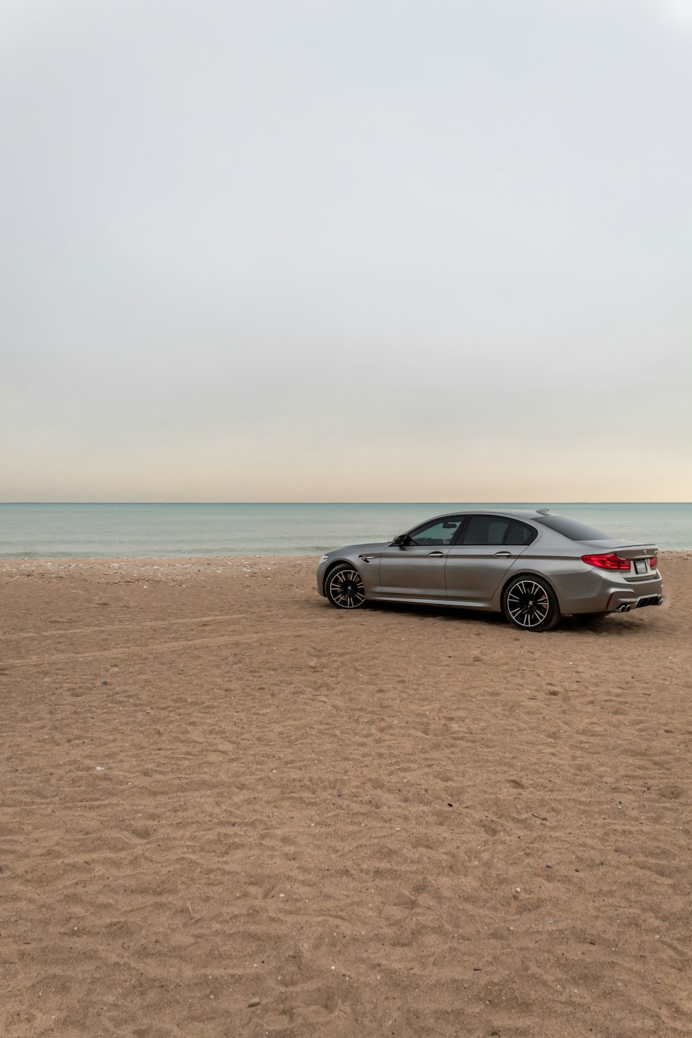 a car parked on a beach near the ocean