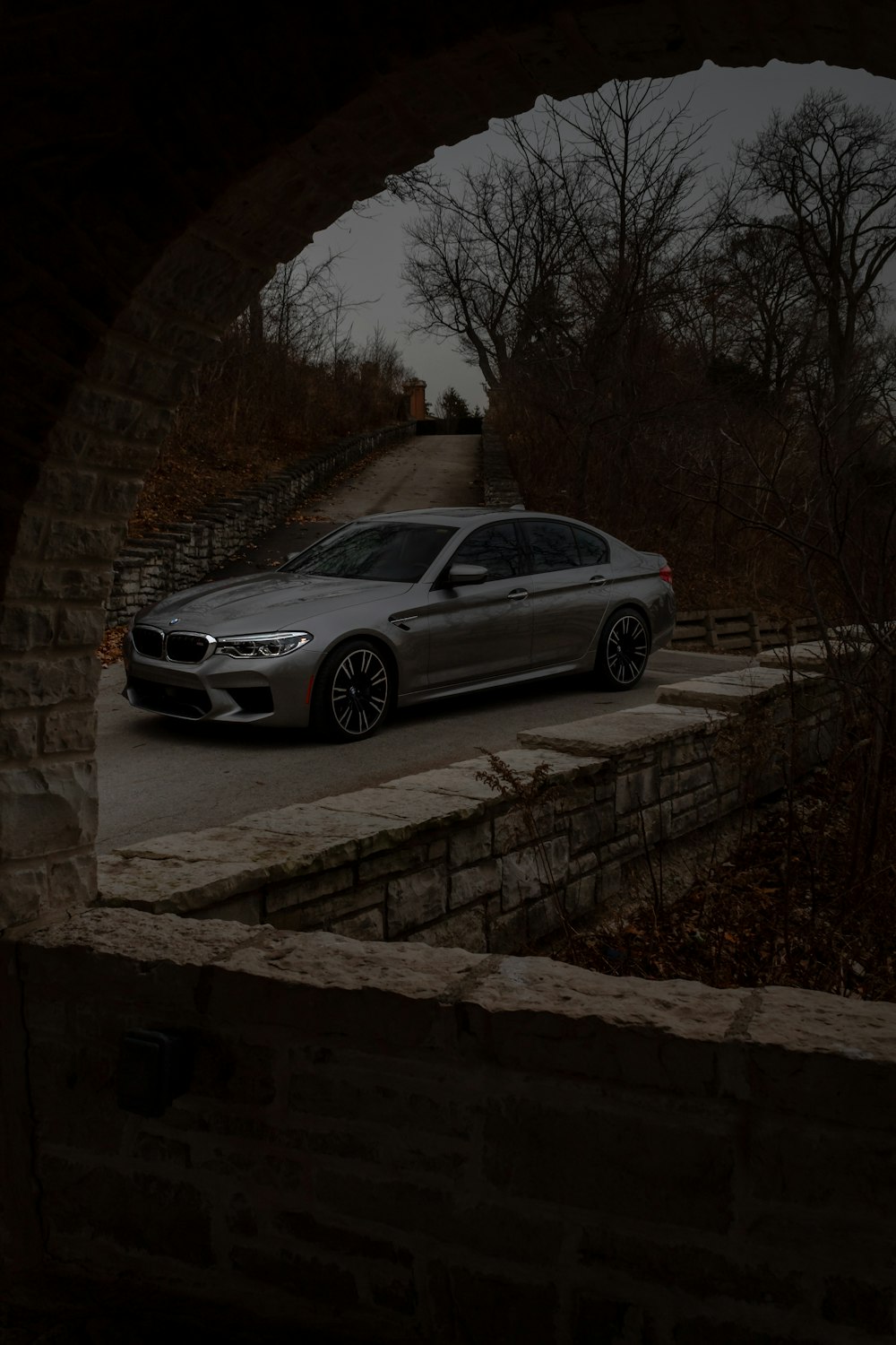 a silver car is parked on the side of a road